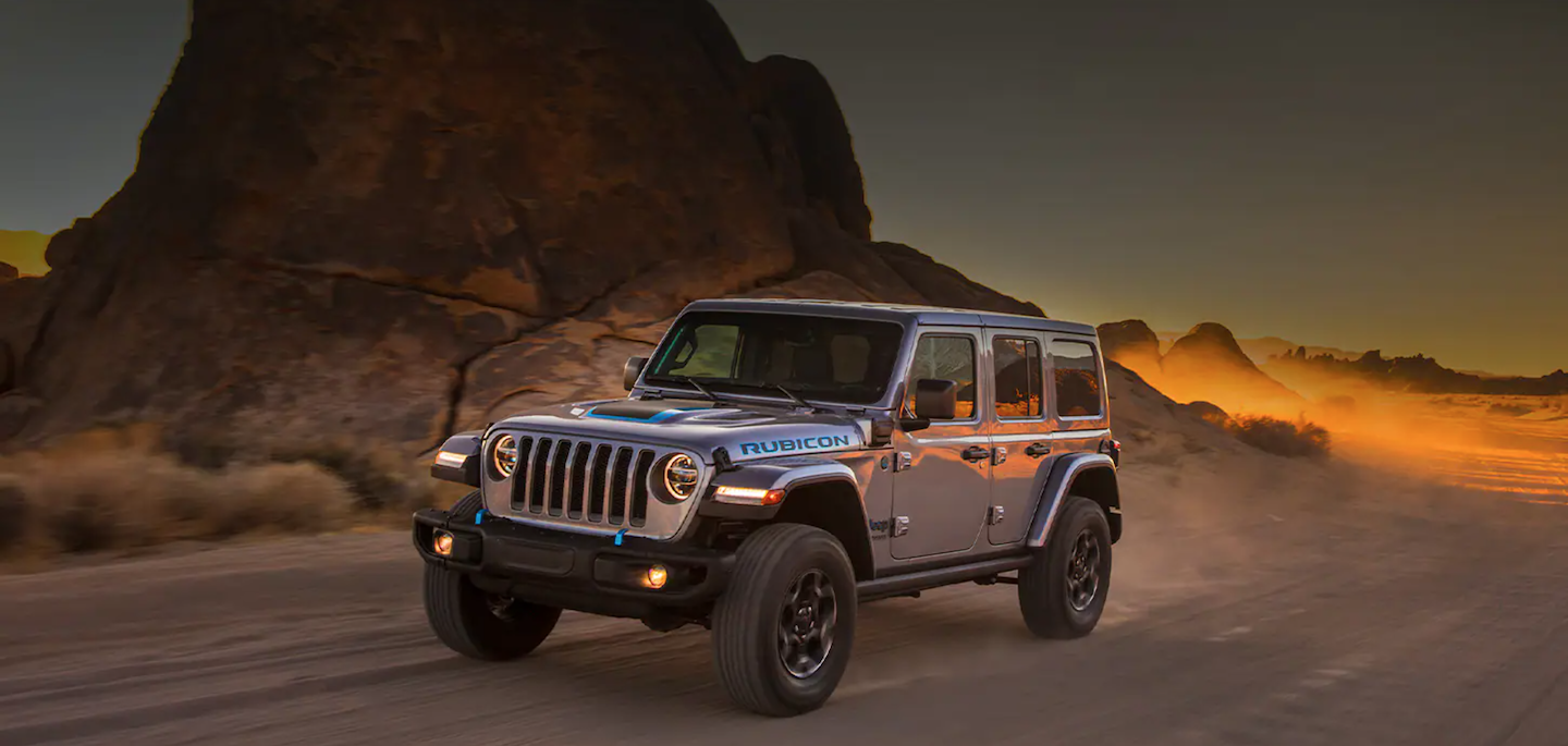 The 2021 Jeep Wrangler 4xe driving through the desert.