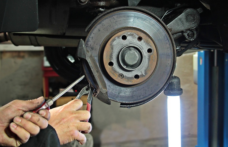 A close of a brake repair being performed by a mechanic 