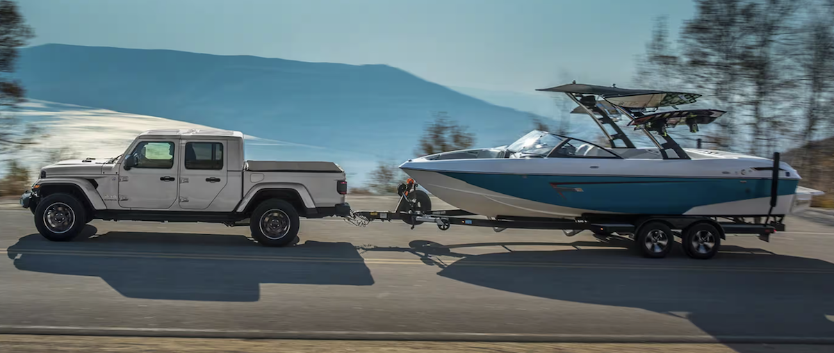 side view of a 2023 Jeep Gladiator towing a boat
