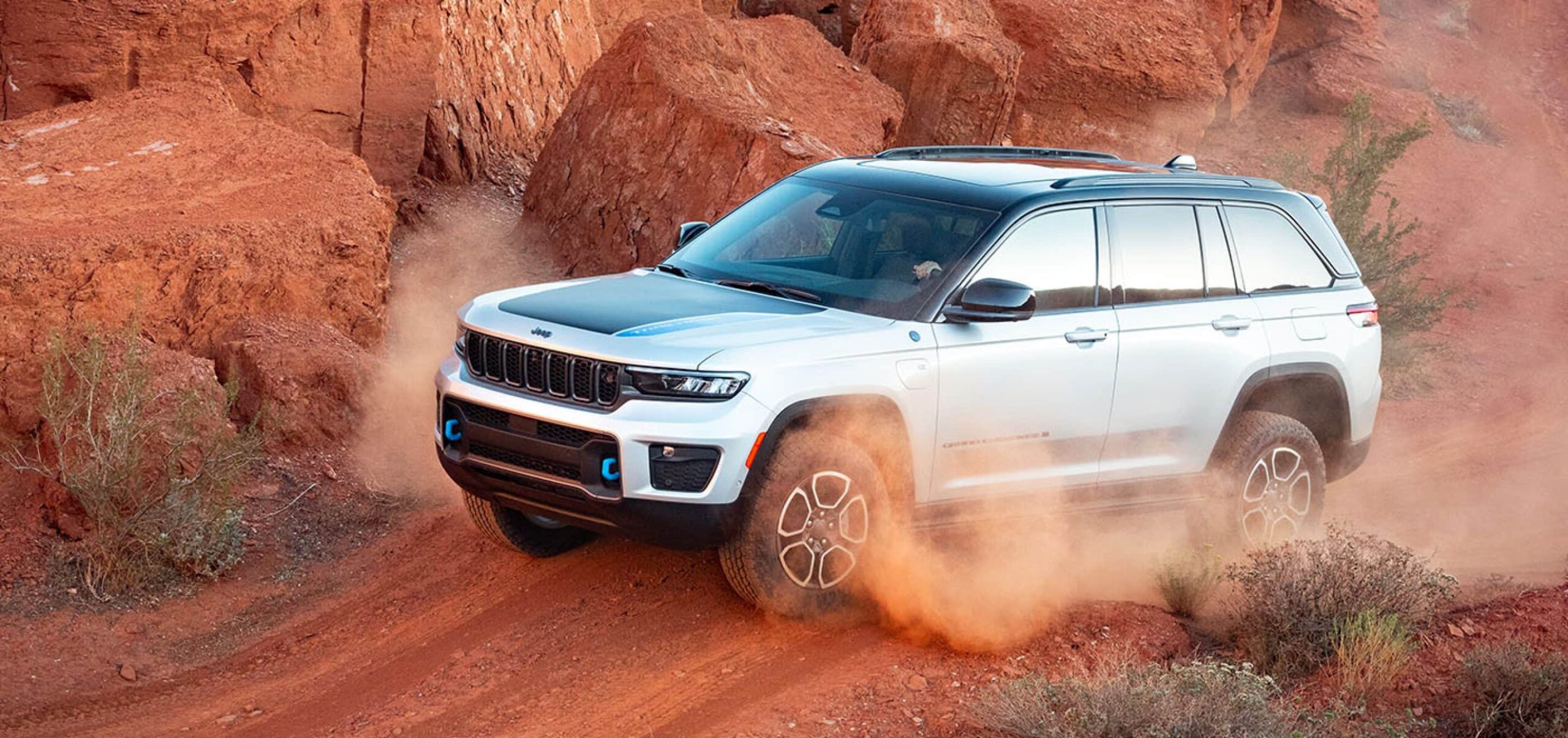 Angled picture of Jeep Grand Cherokee driving through desert