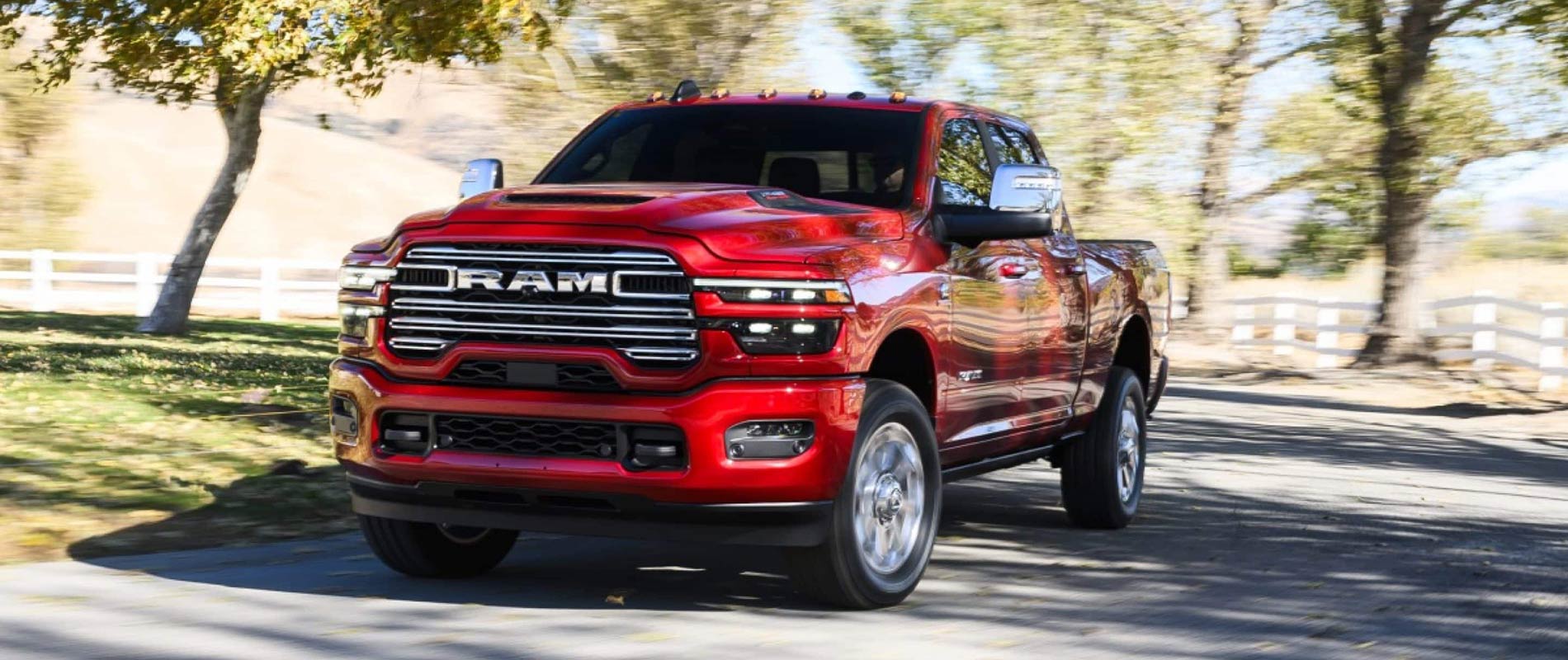 A red 2026 RAM 2500 driving down the road.