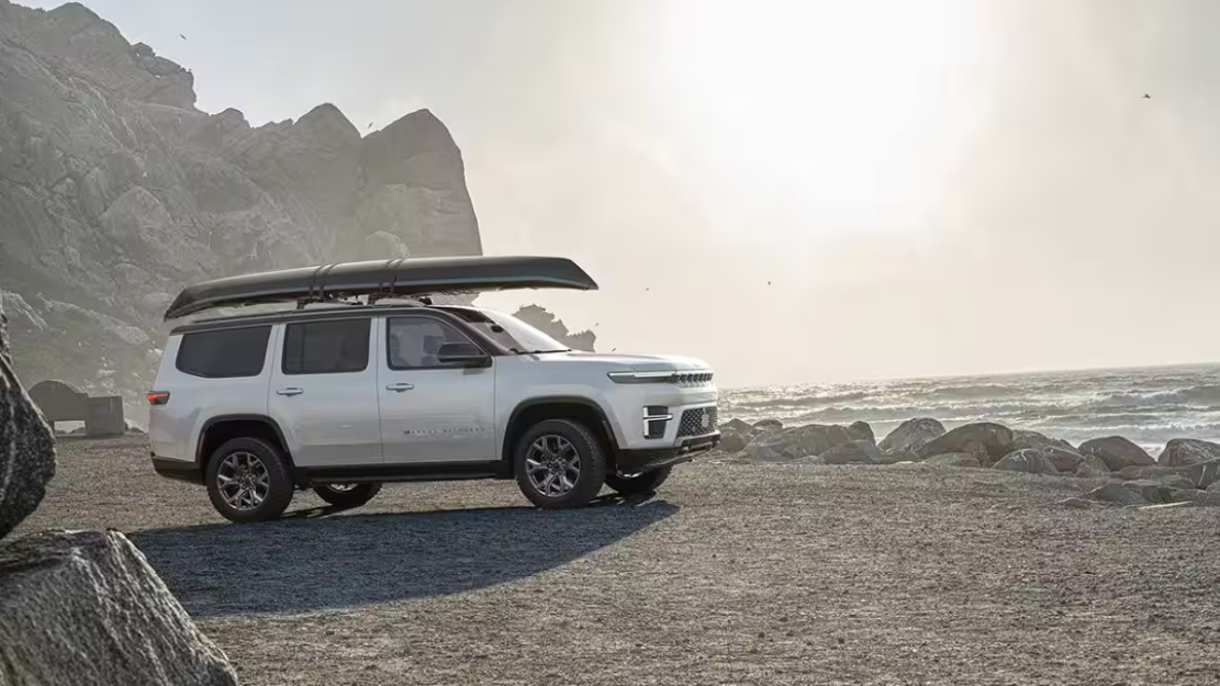  2026 Jeep Grand Wagoneer parked on gravel by a body of water