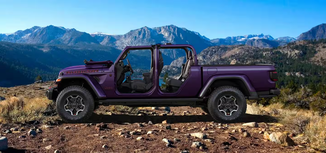 Side profile of a 2026 Jeep Gladiator Rubicon in purple in a mountainous setting