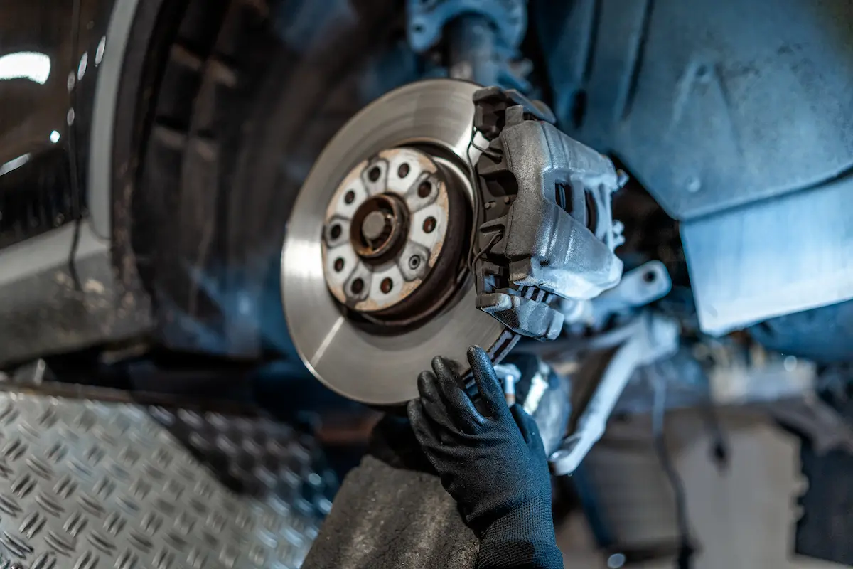 A close of a brake repair being performed by a mechanic 