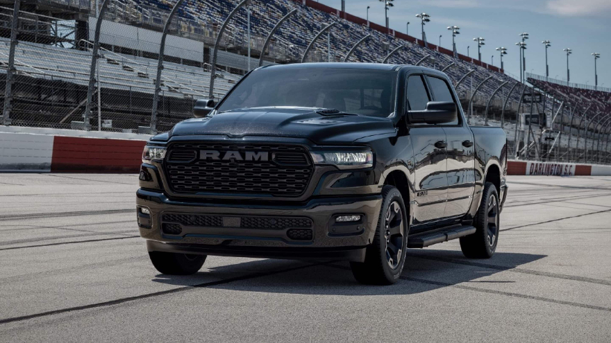 A black RAM 1500 on a race track.