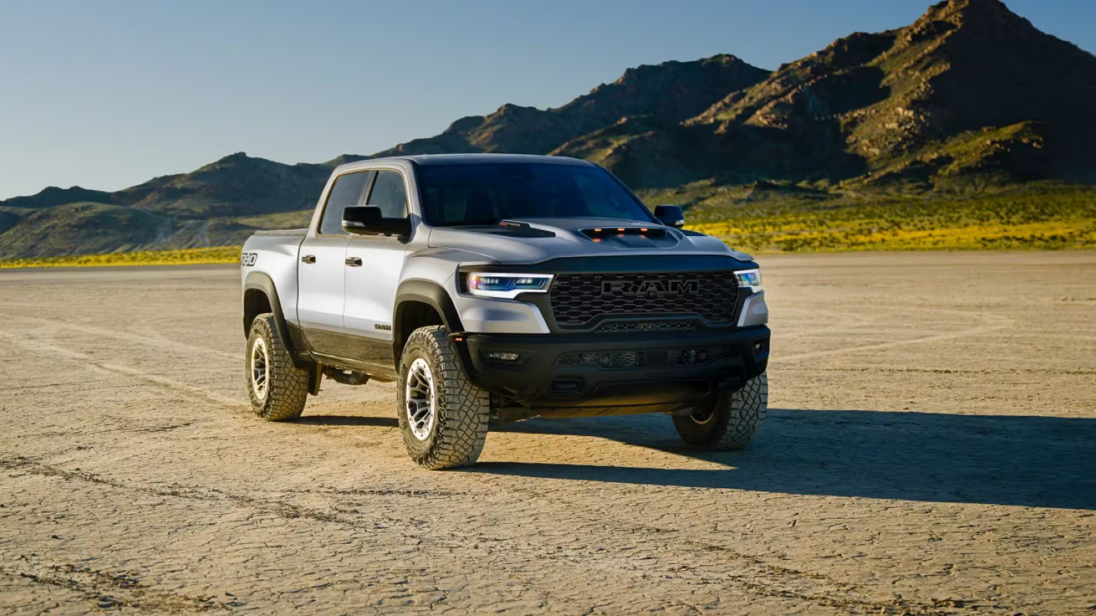 A silver RAM 1500 out on a dirt road.